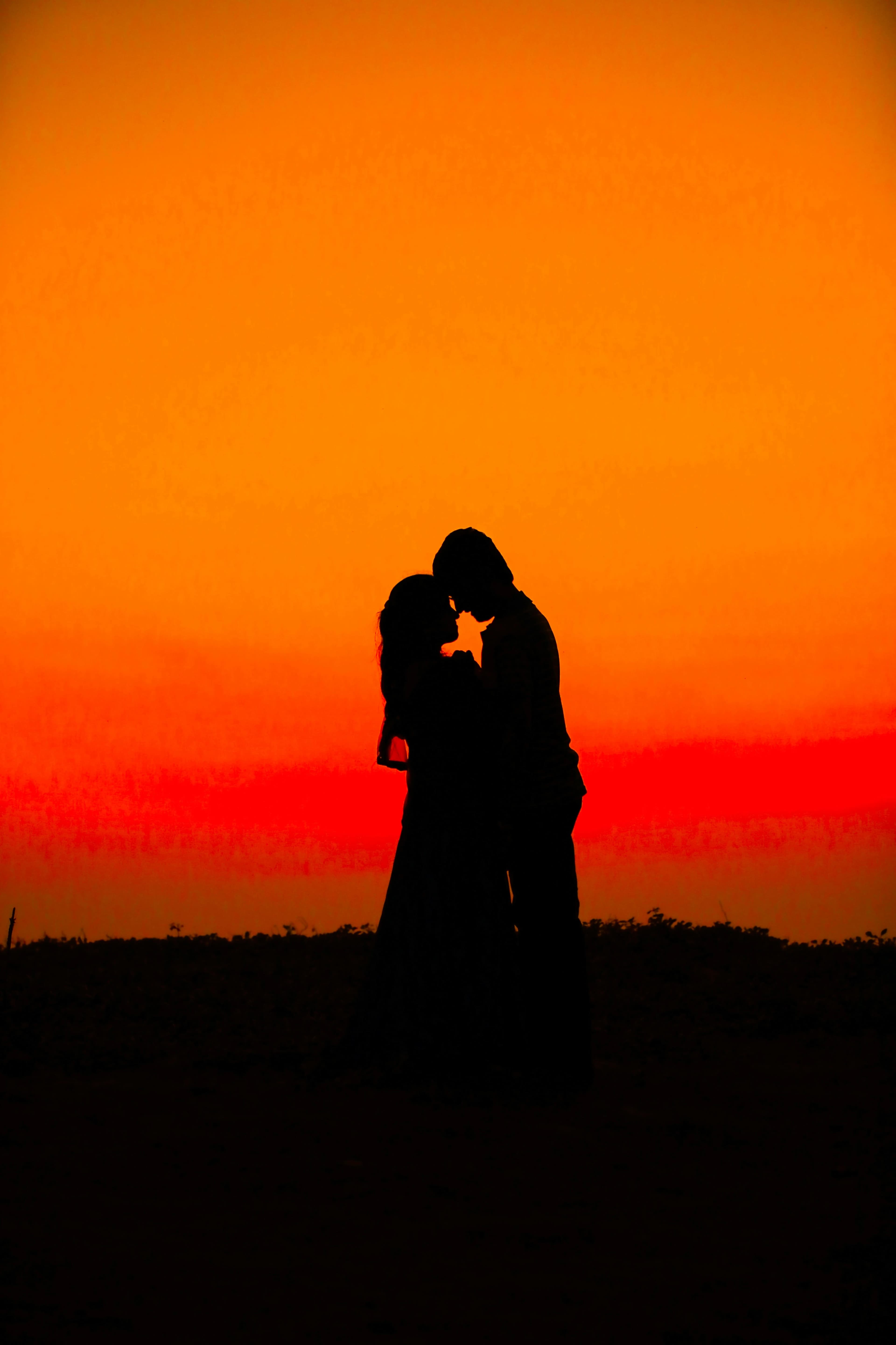 casal beijando no pôr do sol