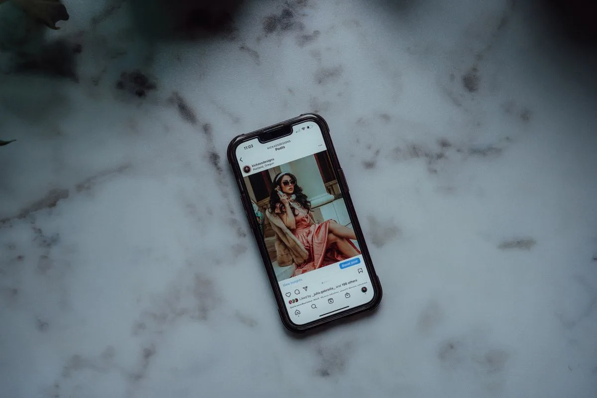 A smartphone displaying an Instagram post on a marble surface